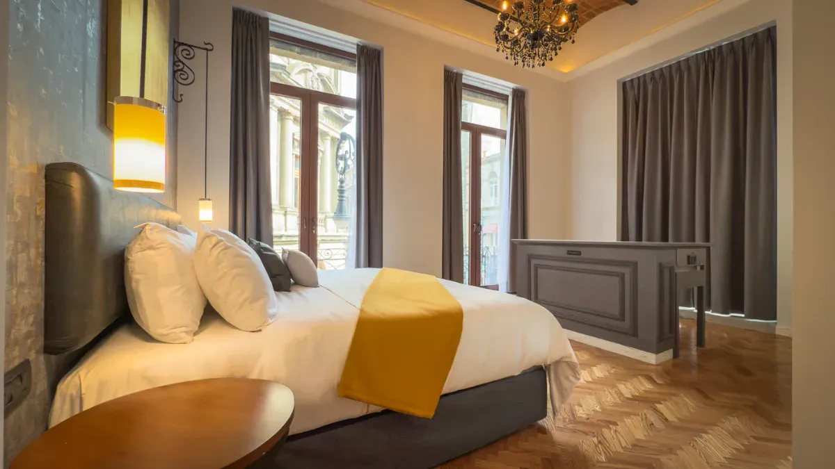 King Suite with Balcony and Interior Tub at Hotel Bellas Artes. With city view and interior tub and television.