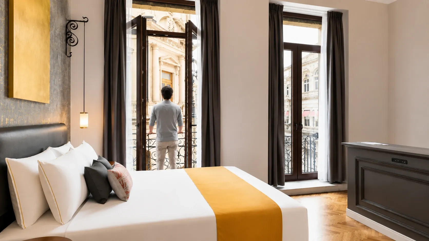 View from the balcony of the King Suite featuring a King bed, a spacious balcony with views of historic 5 de Mayo street. Two balconies and one of the most luxurious rooms in Mexico City's Historic Center.