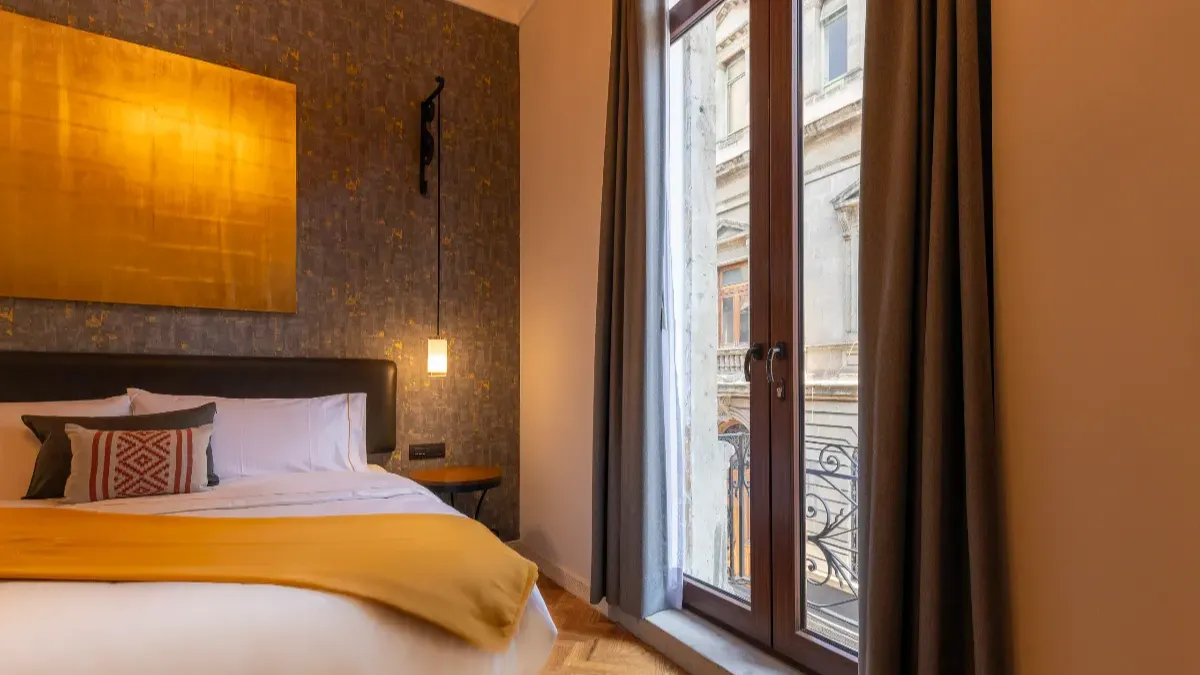 Balcony view overlooking Filomeno Mata street. The TV, balcony, and bed are visible.